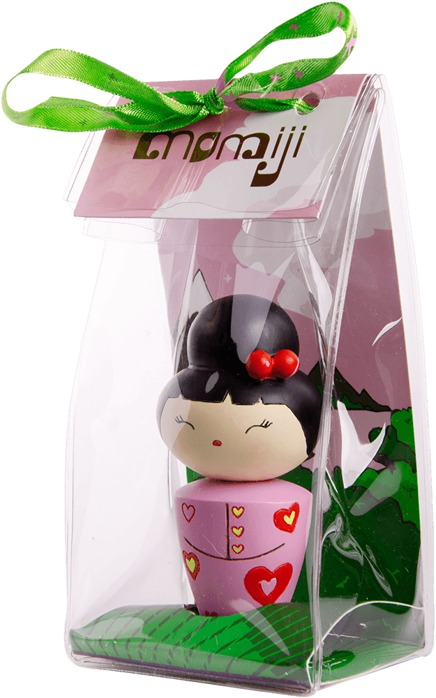 Cha cha cha is a Momiji doll in a pink heart dress, with secret message slot, in a clear box tied with green ribbon and tag. — Momiji Doll