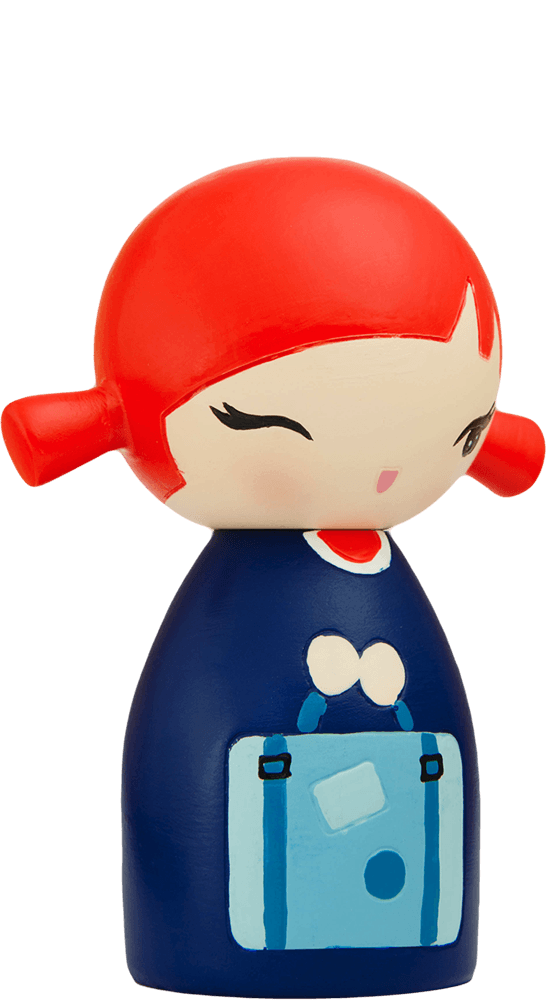 The Poppet Momiji doll has red hair, a blue dress, a bag, and a sweet painted face. Each Momiji doll hides a secret message. — Momiji Doll