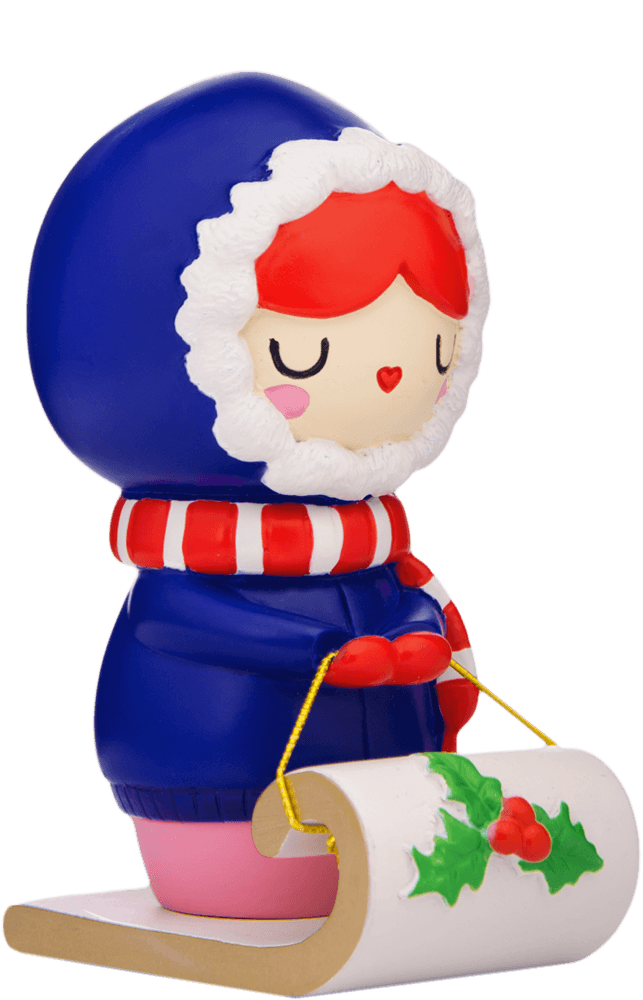 Pipaluk Momiji doll in a blue hooded coat rides a sled decorated with holly leaves and red berries. — Momiji Doll
