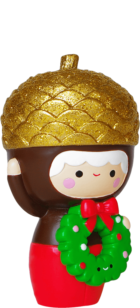 Baby Bellota Momiji doll with a gold acorn hat, red pants, and a festive green wreath with a red bow. — Momiji Doll