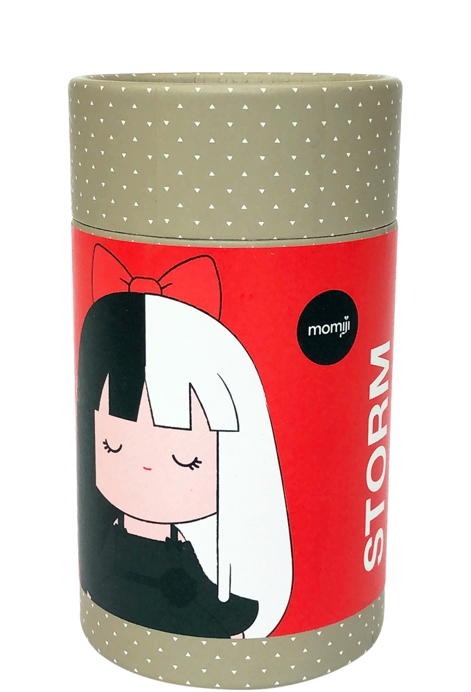 A cylindrical container with the Storm Momiji doll, half black and half white hair, labeled "STORM" and "momiji". — Momiji Doll