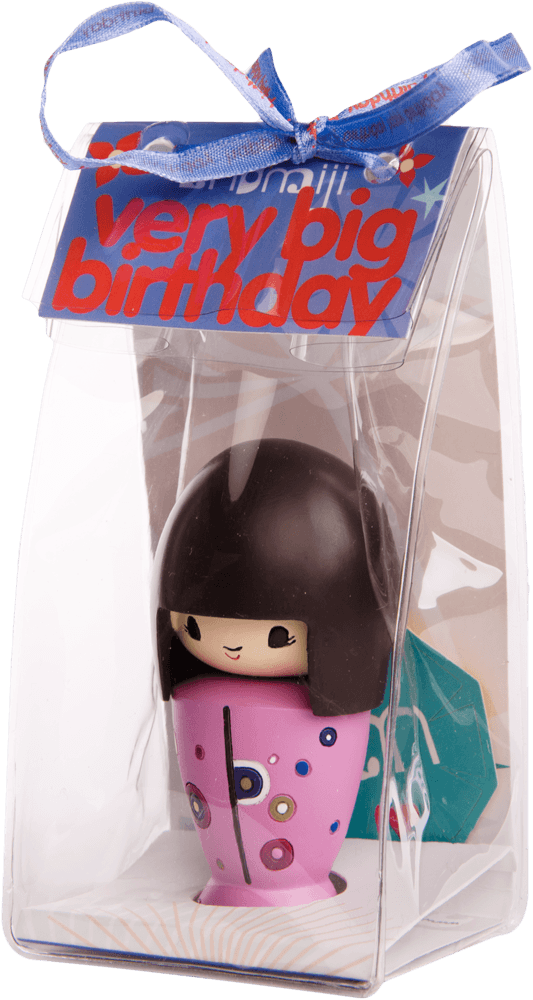 A Very Big Birthday Momiji doll with black hair, in a clear gift box topped with a bright blue ribbon. — Momiji Doll