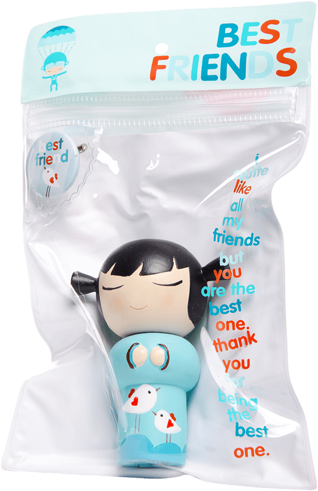 A small black-haired Momiji doll in blue "Best Friends" packaging with a friendship quote on the front. — Momiji Doll