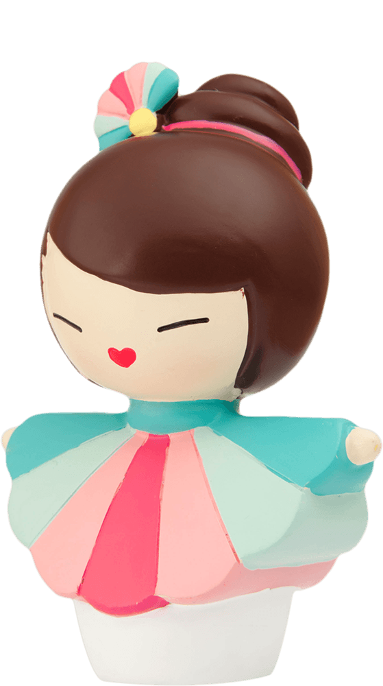 The Hero Momiji doll has brown hair in a bun, wearing a pastel pink, blue, and red dress with kawaii details. — Momiji Doll