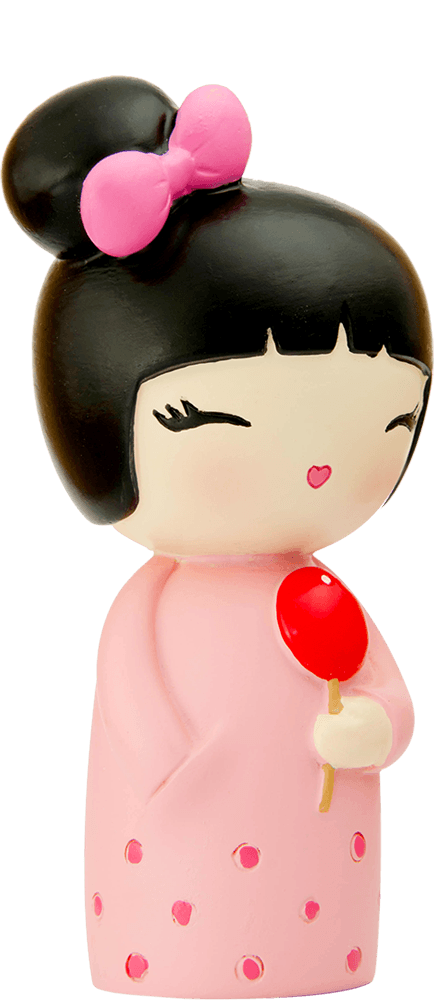 Birthday Girl Momiji doll with black hair in a bun, pink bow, pink dress, and holding a bright red lollipop. — Momiji Doll
