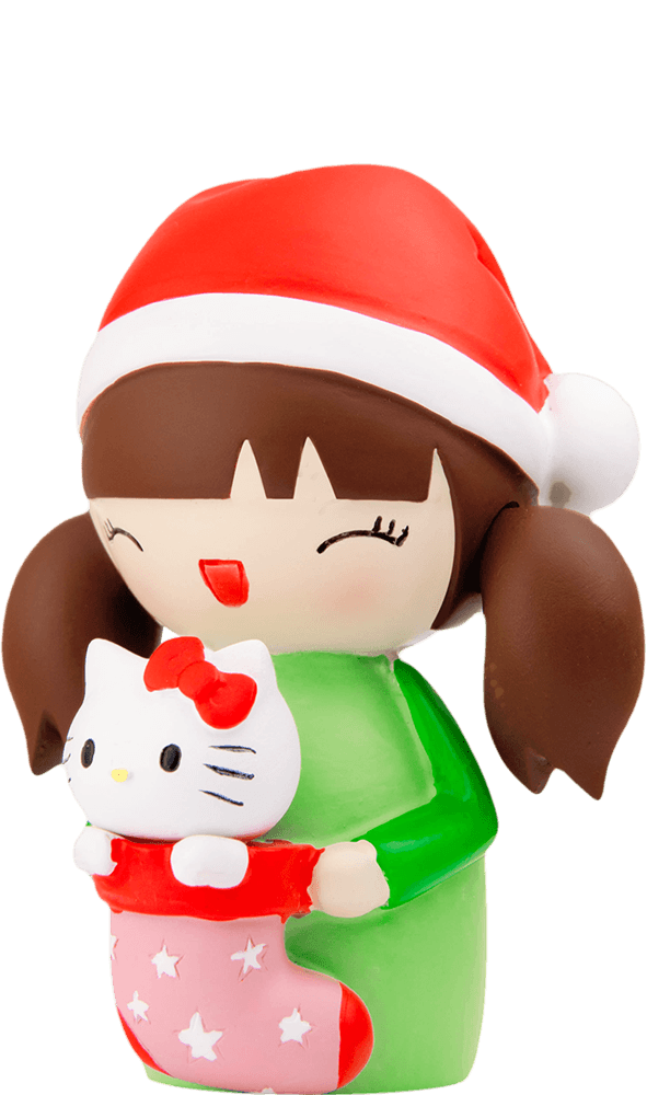 Momiji doll Suki has brown pigtails, a Santa hat, smiling face, and holds a red stocking and cute Hello Kitty toy. — Momiji Doll
