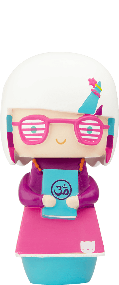 Enid Momiji doll with white hair, pink glasses, pink dress, holding a blue book featuring an Om symbol. — Momiji Doll