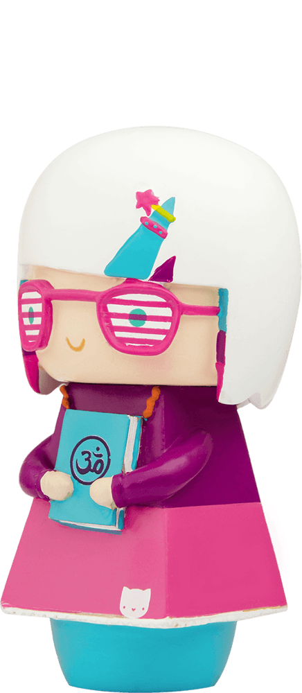 Enid Momiji doll with white hair, pink glasses, party hat, and an Om symbol book. Collectible vinyl character with hidden note. — Momiji Doll