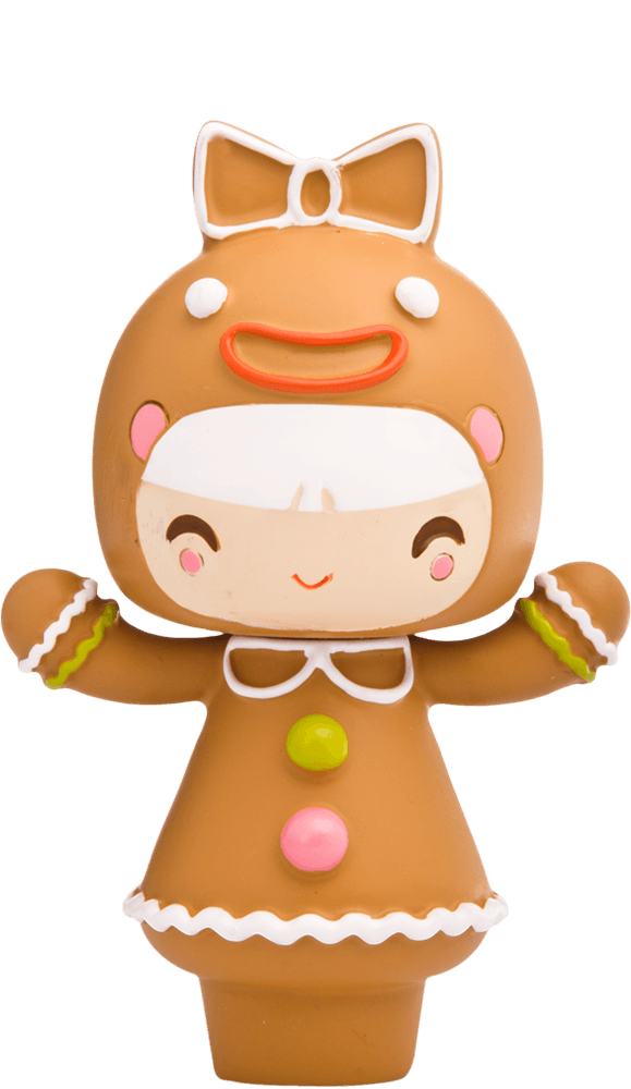 Treacle Momiji doll is dressed as a gingerbread cookie with icing details, colorful buttons, and a large bow on its head. — Momiji Doll
