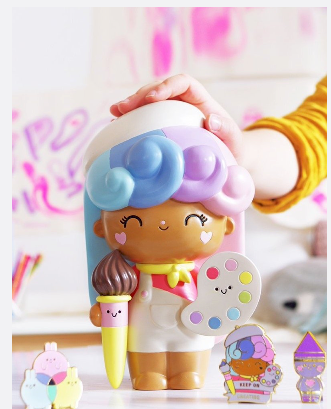 The Create | Big Ideas 2020 Momiji doll with pastel hair holds a paintbrush and palette, grinning, ready to make art. — Momiji Doll