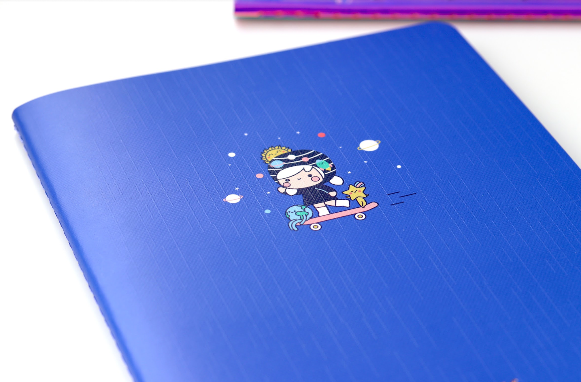 Going Places Momiji doll on skateboard wearing VR goggles with animals and planets, featured on A5 linen notebook cover. — Momiji Doll