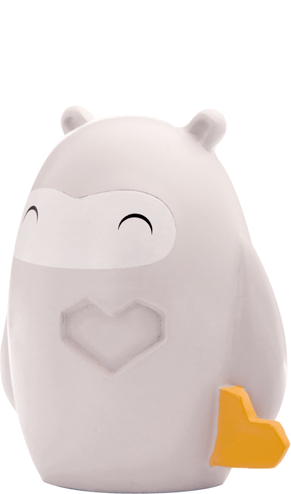 Kindness Momiji doll is round and gray, holding a yellow geometric heart with a smiling face and "bravery" on its chest. — Momiji Doll