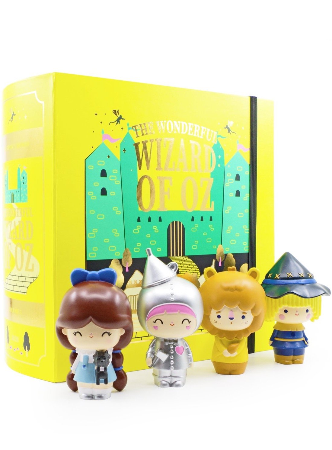 Four Wizard of Oz Momiji dolls with colorful outfits stand before the limited edition book The Wonderful Wizard of Oz. — Momiji Doll