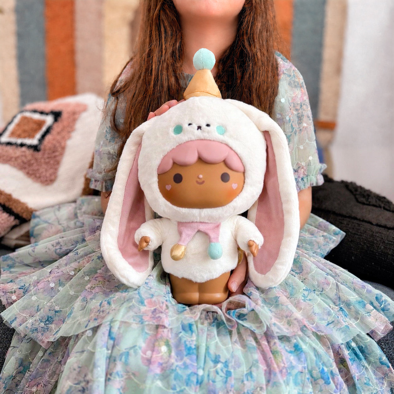 Momiji doll in a pastel dress holds Sugar Plum Collector’s Edition Plush | Bonbon Butterkins with a bunny hat. — Momiji Doll