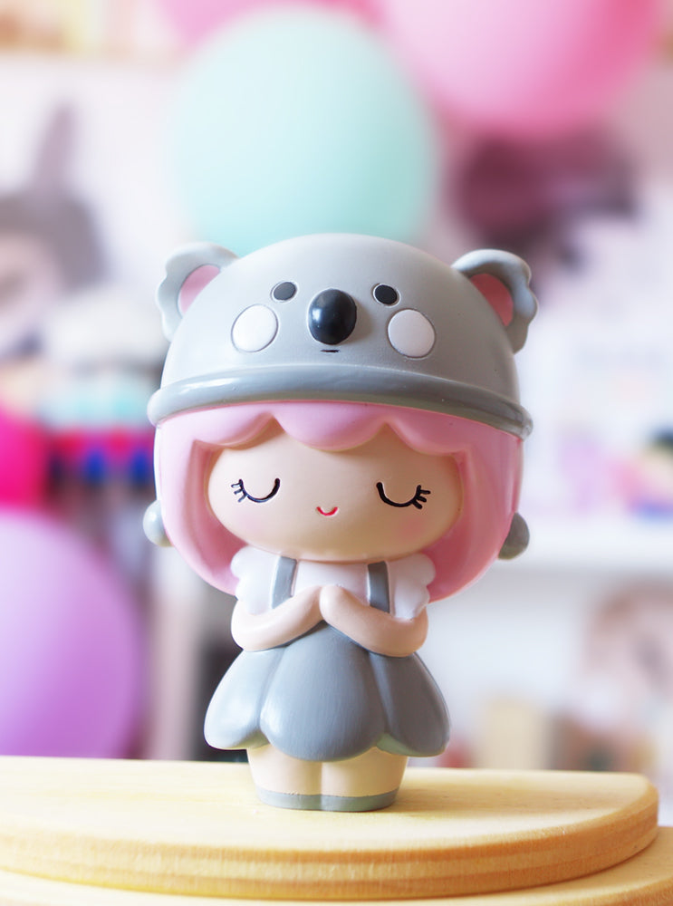 Koalamama Momiji doll with pink hair, a gray koala hat, and secret message slot. Playful collectible character from Tokyo & Seoul culture. — Momiji Doll