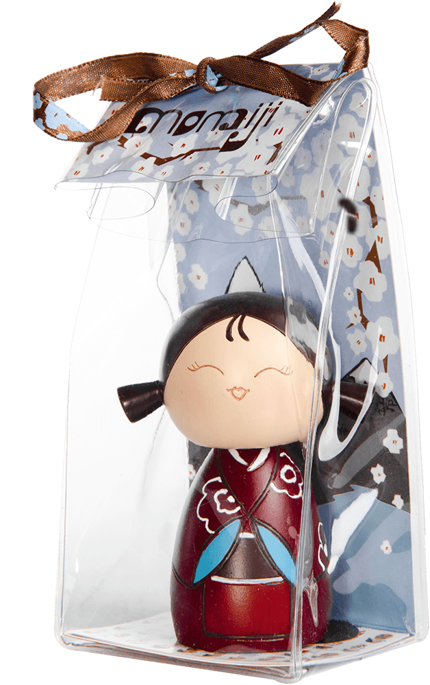 Giggles Momiji doll, smiling in a clear gift box with a brown ribbon and floral tag. Cute collectible with secret message inside. — Momiji Doll