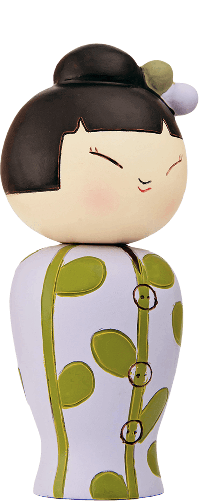 Higgledy-piggledy Momiji doll with painted face, black bun hair, white dress with green polka dots. — Momiji Doll