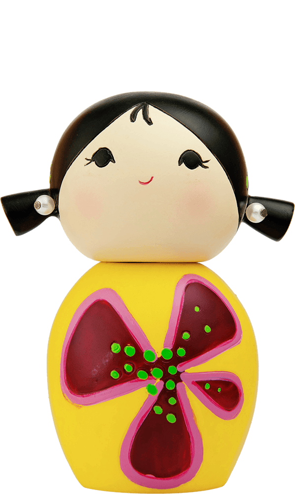 Dreaming Momiji doll with black pigtails, yellow dress, and a large red and pink flower on the front. — Momiji Doll