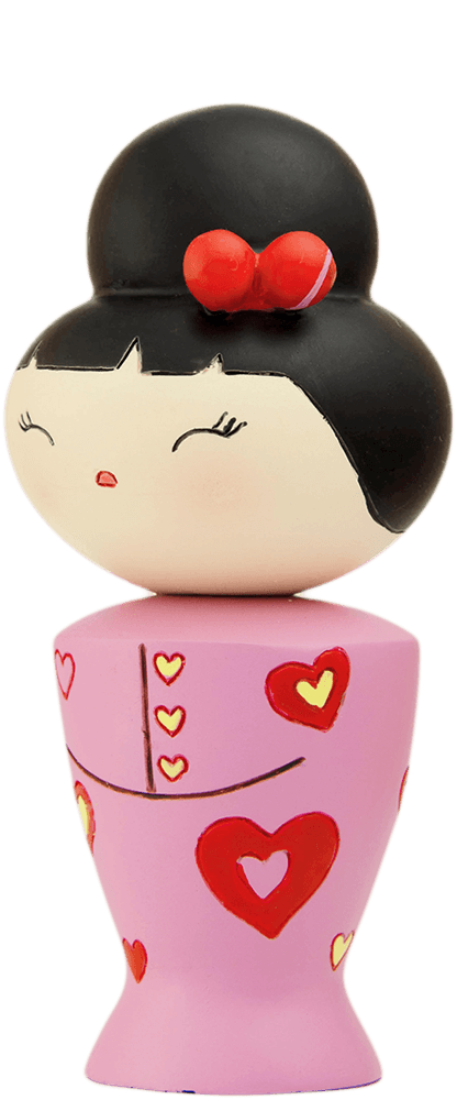The Cha cha cha Momiji doll has black hair, a red bow, and a pink dress decorated with red and yellow hearts. — Momiji Doll