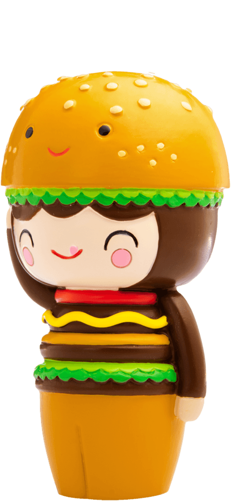Giggles Momiji doll dressed as a hamburger, with bun hat, lettuce, cheese layers and a sweet smiling face. Collectible kawaii design. — Momiji Doll