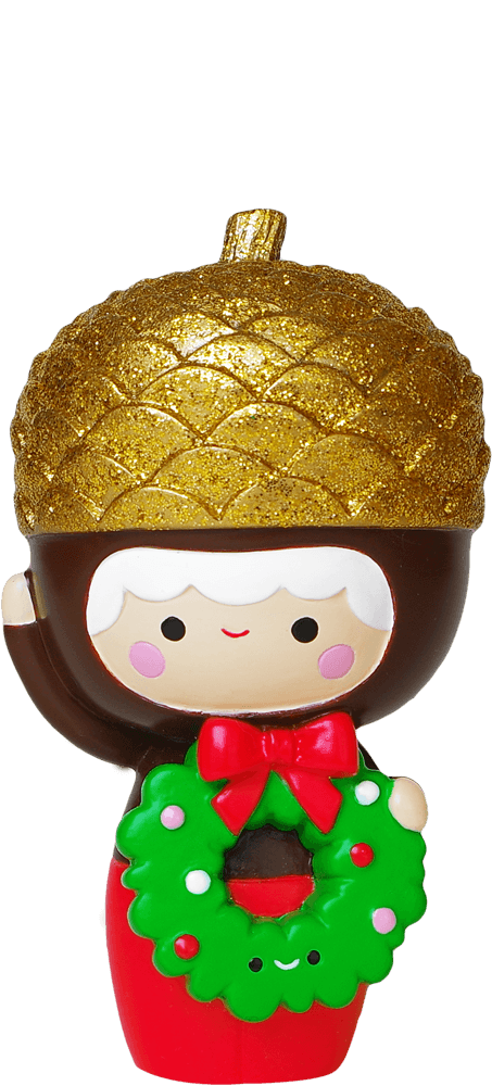 Baby Bellota Momiji doll wears a gold acorn hat, red outfit, waves and holds a green wreath with a red bow. — Momiji Doll