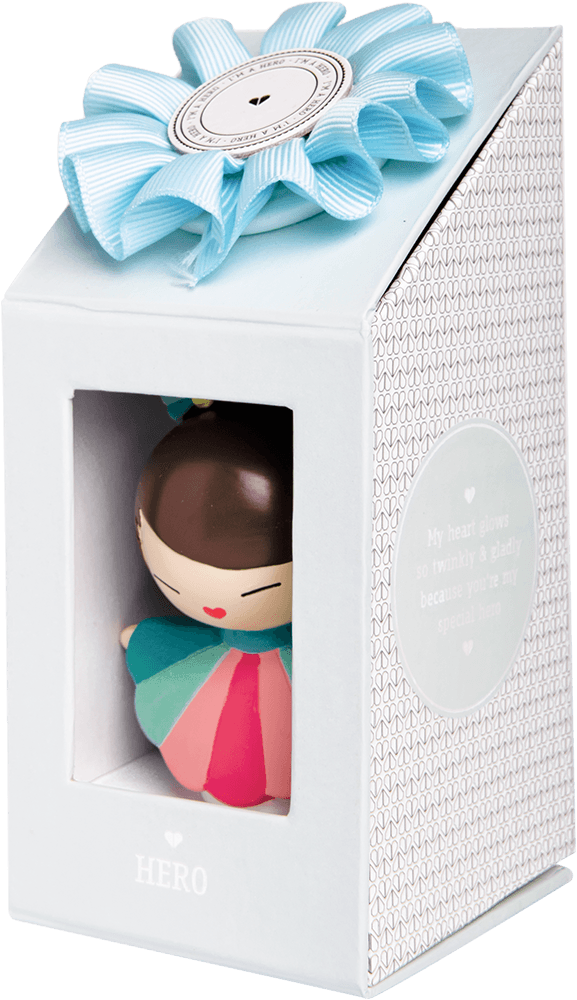 The Hero Momiji doll in a pastel dress, packaged in a white gift box tied with a blue ribbon. — Momiji Doll