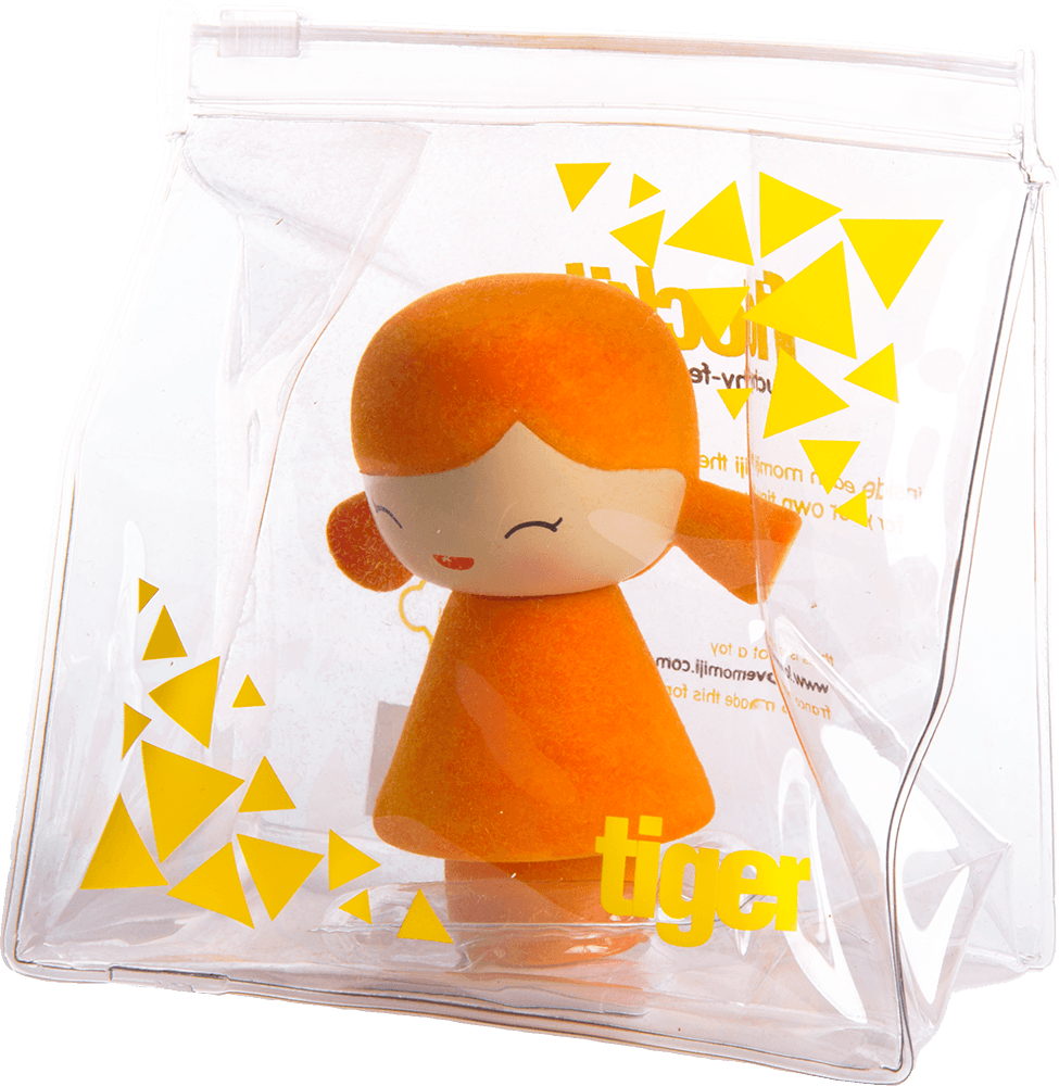 An orange Tiger Momiji doll with closed eyes, inside a clear bag decorated with yellow triangles. — Momiji Doll