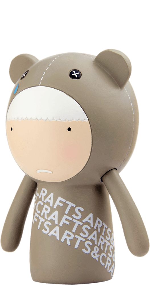 Ted Momiji doll in a bear onesie, blue teardrop detail, CRAFTSARTS text. Vinyl collectible hiding a secret message inside. — Momiji Doll