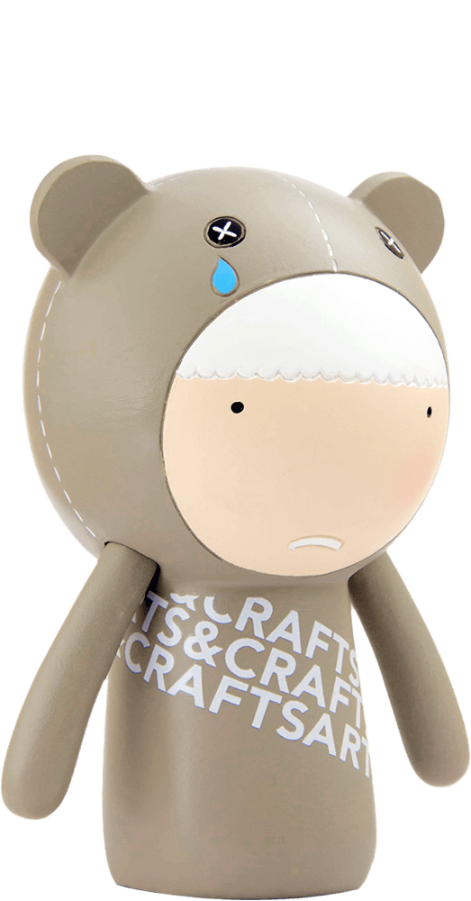 Ted Momiji doll in a bear costume with cross eyes, teardrop detail, and "CRAFTS & CRAFTS" on its chest; kawaii collectible. — Momiji Doll