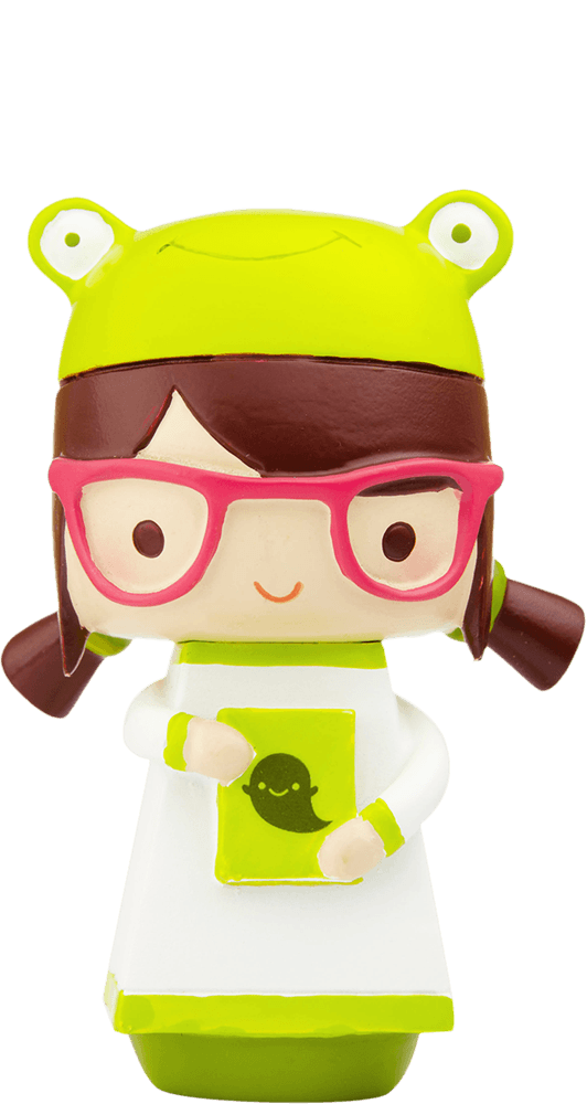 Phoebe Momiji doll with glasses, brown pigtails, frog hat, and green book featuring a smiling creature on the cover. — Momiji Doll