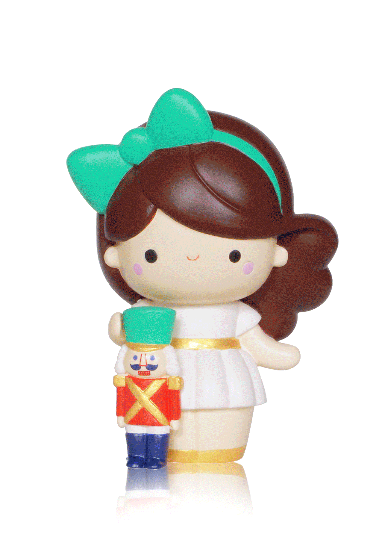 Momiji doll with brown hair, green bow, white dress, holding a Nutcracker toy soldier; cute collectible design. — Momiji Doll