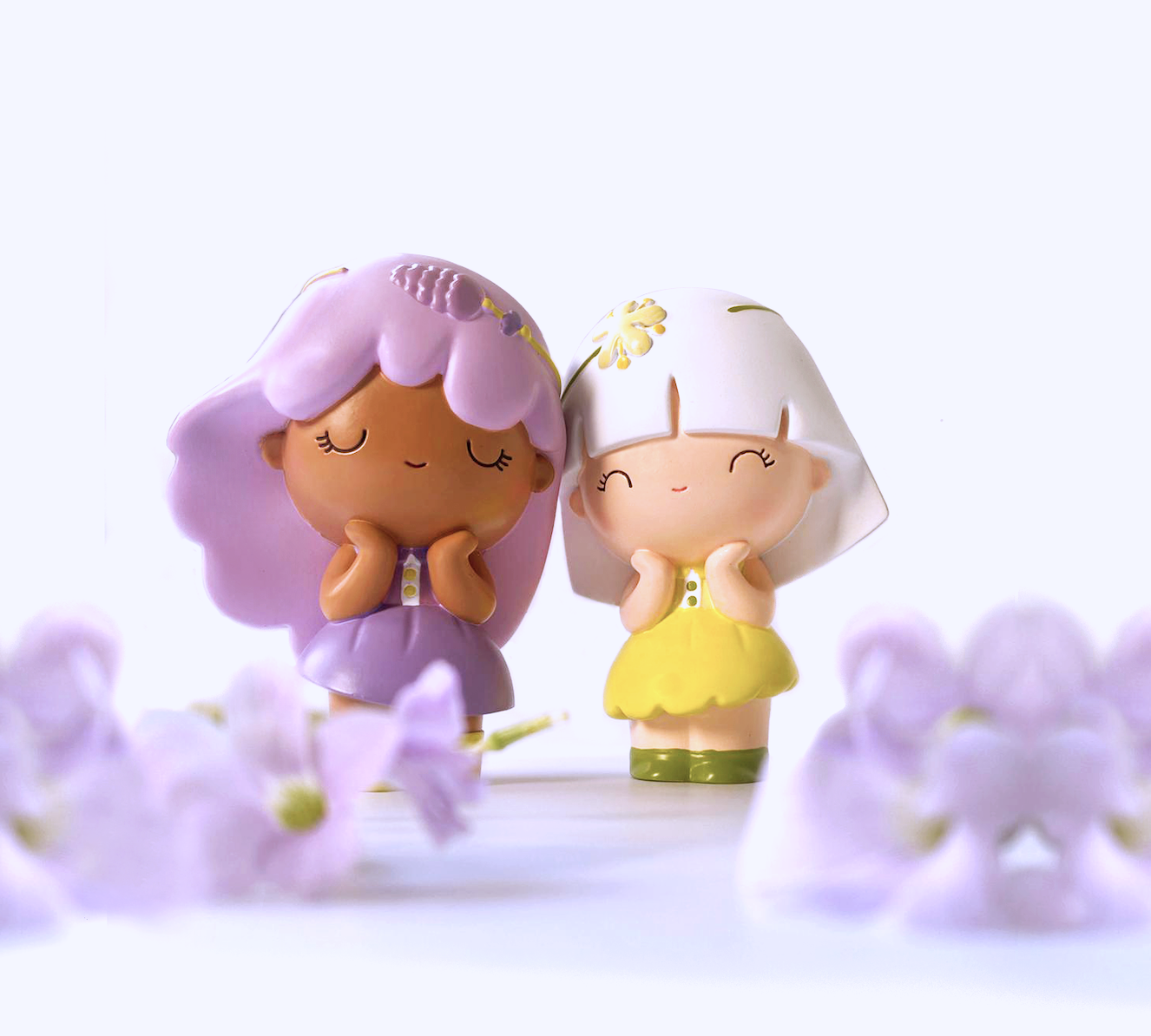 Linden Momiji dolls with pastel hair and sweet smiles stand among purple flowers; collectible kawaii character dolls. — Momiji Doll
