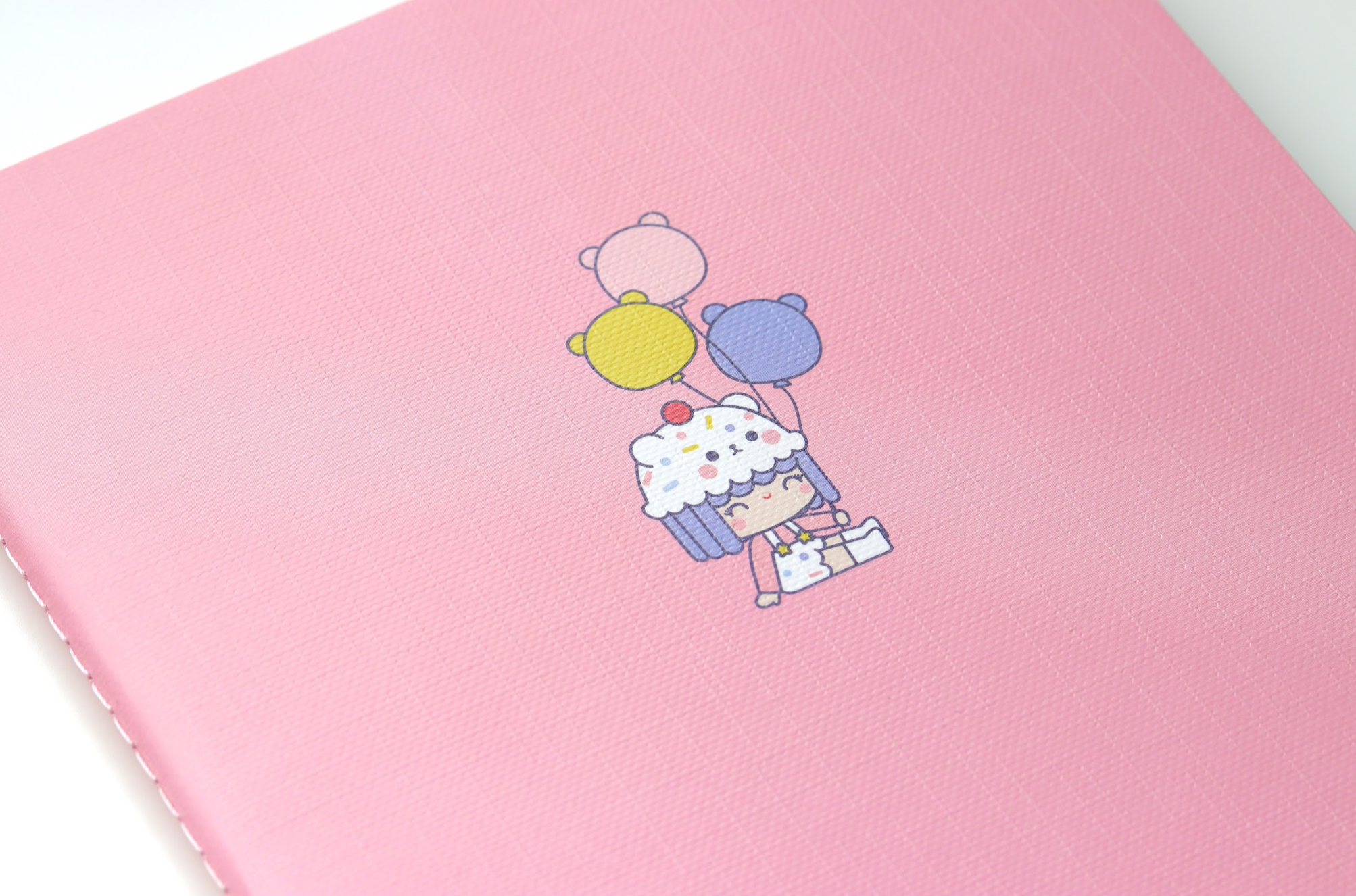 The HAPPY DAYS NOTEBOOK shows a Momiji doll with cupcake hair and bear balloons on an A5 ruled cover, kawaii style. — Momiji Doll