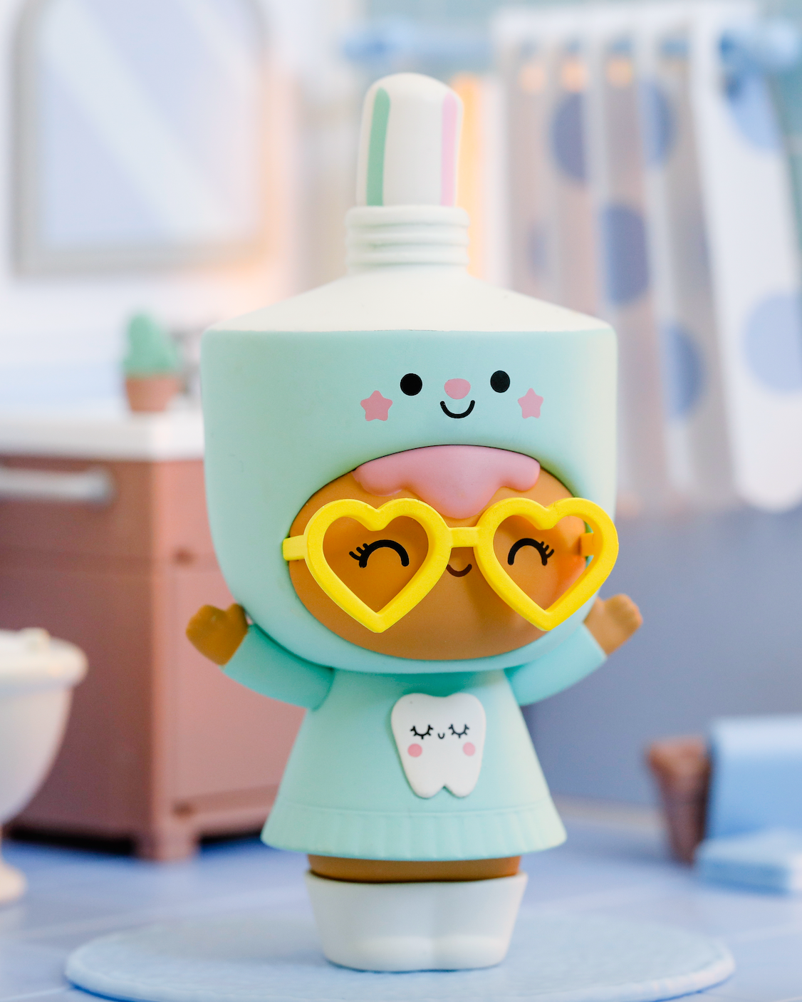 Dazzle Momiji doll as a toothpaste bottle with heart glasses, tooth print, and cap in a bright bathroom scene. — Momiji Doll