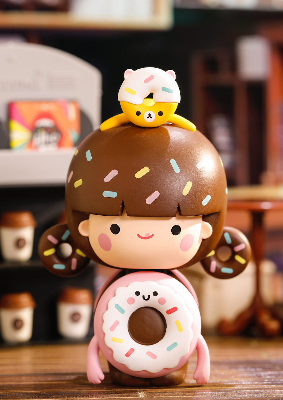 Perfect Partners - Sprinkles: Momiji doll with donut frosting, sprinkles, holding a tiny bear in a colorful cozy cafe scene. — Momiji Doll