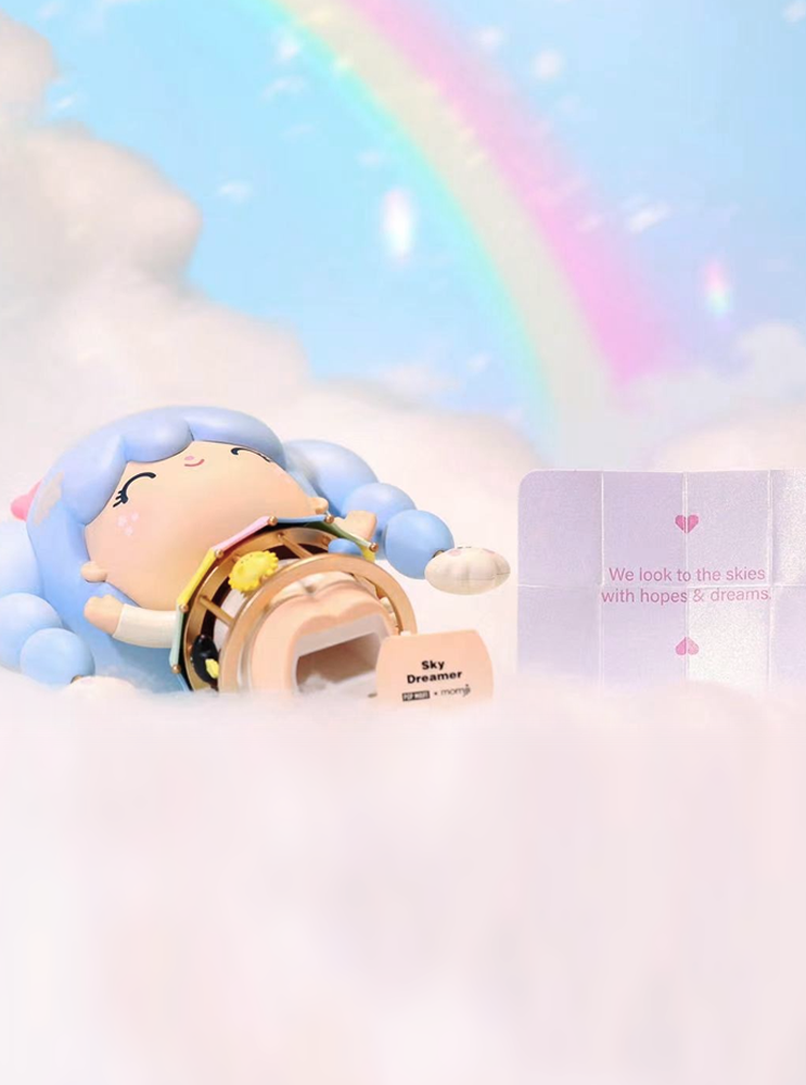 Sky Dreamer Momiji doll with blue hair lies on clouds, rainbow behind, holding a secret message card. Kawaii and collectible. — Momiji Doll